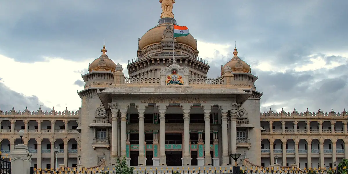 Vidhana Soudha in Bangalore, stone facade under cloud.